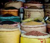 Some open bags, each filled with a different kind of beans or lentils etc.