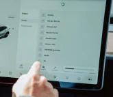 Person configuring his car on a touchscreen