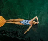 A woman with a big mono-fin swimming in a pool