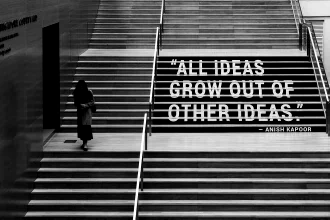 The quote “All ideas grow out of other ideas” written on a a large stairway