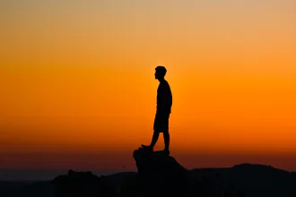 Shadow of a lone man in the sunrise